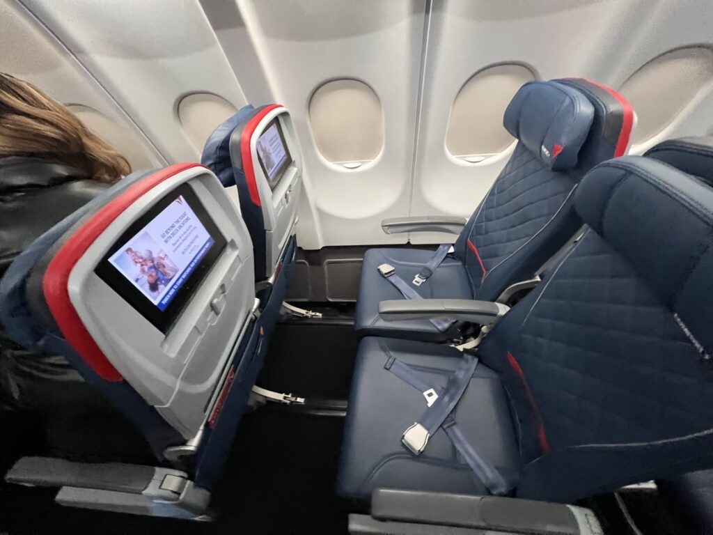 Delta A330-200 extra legroom Comfort+ seats in dark blue with red detailing.