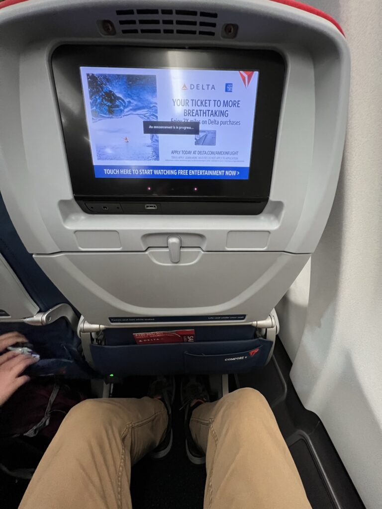 Delta A330-200 embedded IFE. A man's knees are also visible.