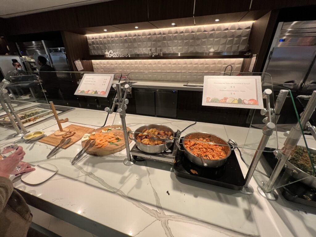 Buffet of hot food options are displayed in the SkyClub at JFK T4