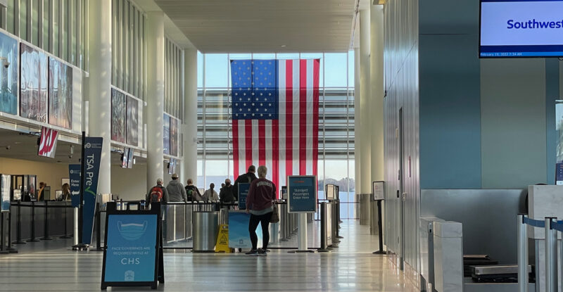 TSA checkpoint flanked by American flag