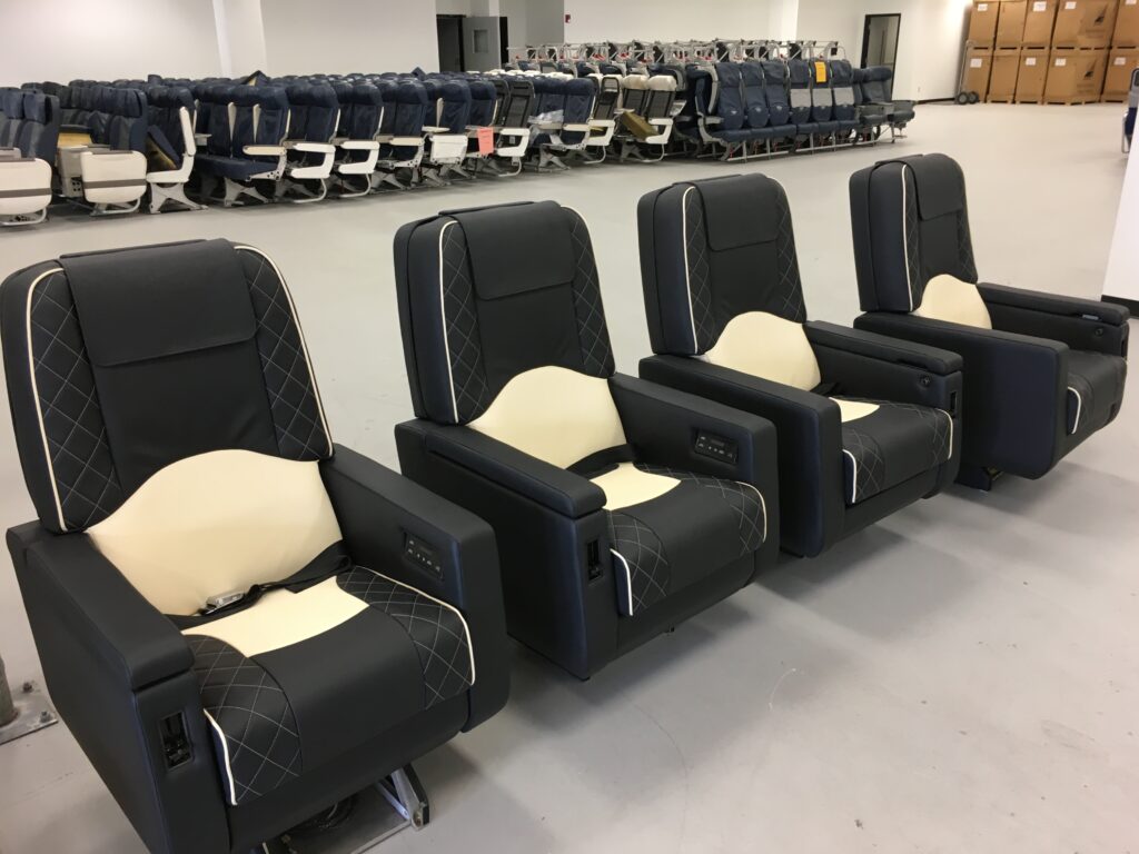 Four pristine premium aircraft seats in Latitude Aero's facility.