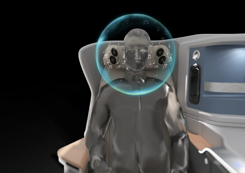 A computer generated image showing a business class seat mock of of an aircraft. A clear figure is seated with a bubble around its head to reflect the Personalized Sound Zone (psz) by Jamco.