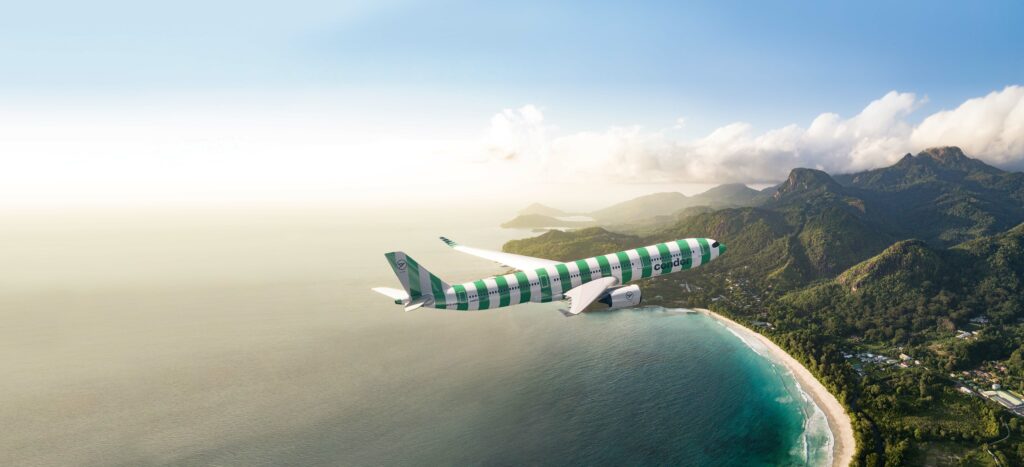 Condor A330 with green livery flying towards the coastline.