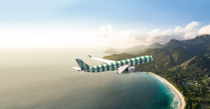 Condor A330 with green livery flying towards the coastline.