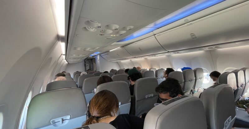 Flair Airline Boeing 737 MAX 8 cabin interior is most grey with blue LED lighting running along the overhead bins.