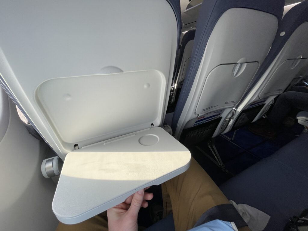 A man is pulling out the small Lynx Air tray table.