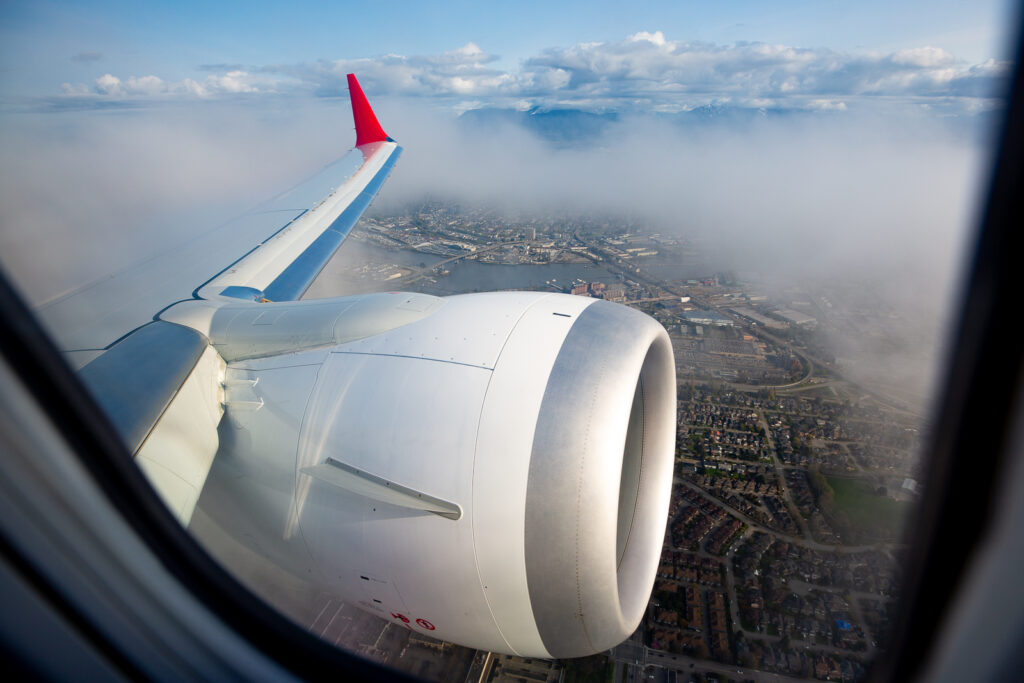 Lynx Air wing tip and engine are seen here out of the aircraft window.