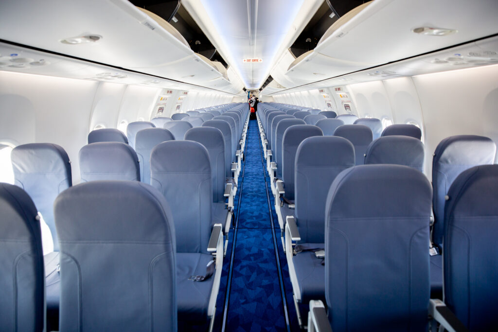 Lynx Air Boeing MAX cabin interior. Blue slimline seats in a 3-3 configuration.