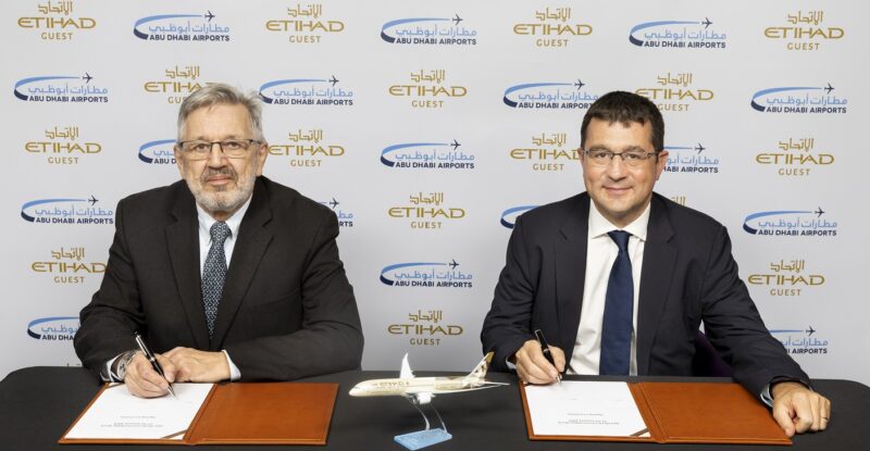 Terry Daly and Francois Bourrienne smile for a photo while singing the Etihad MoU