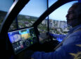 A pilot is sitting the cockpit of an aircraft.