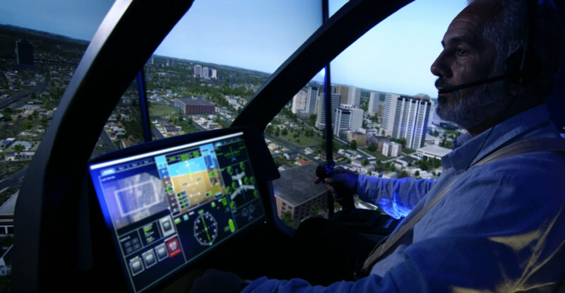 A pilot is sitting the cockpit of an aircraft.