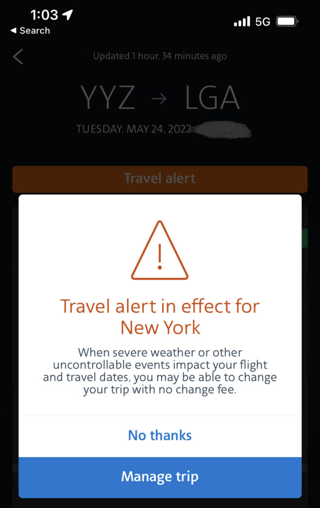 A warning pop-up screen on a mobile device that says "travel alert in effect for New York"