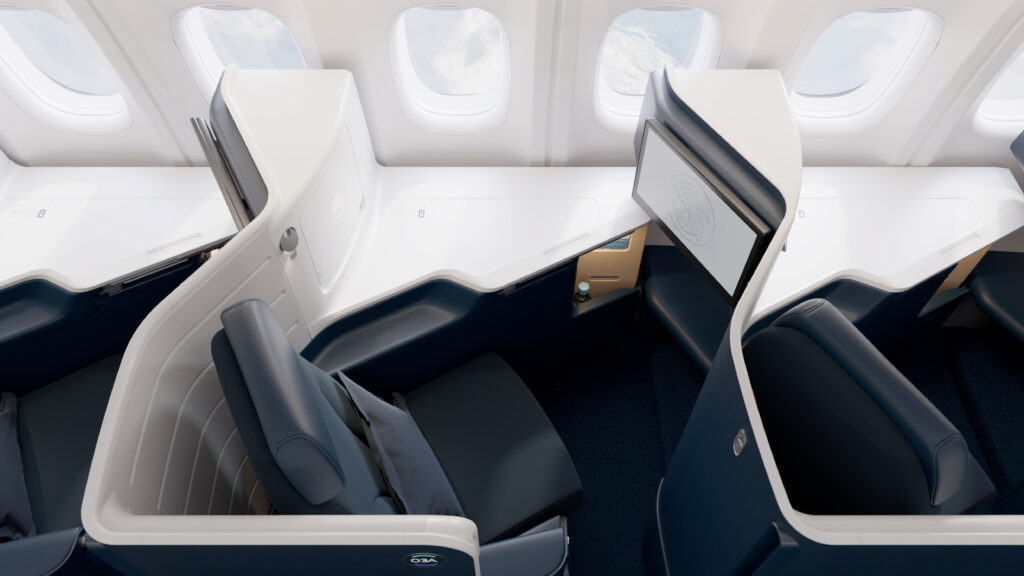 Top down view of business on Air France's Boeing 777-300ER. The seat is navy blue with white walls around it.