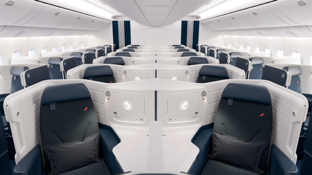 Business Class seats on Air France's Boeing 777-300ER. The cabin is a 1-2-1 configuration of blue seats with white thermoplastic shells on the inside (navy behind).