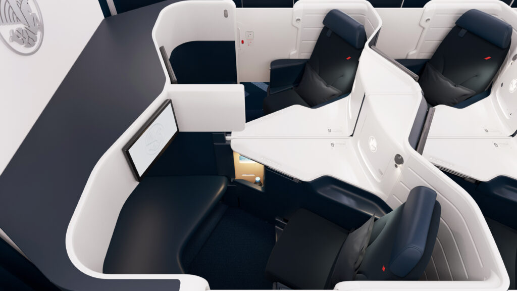 Business Class cabin on Air France's Boeing 777-300ER. The cabin is a 1-2-1 configuration of blue seats with white thermoplastic shells.