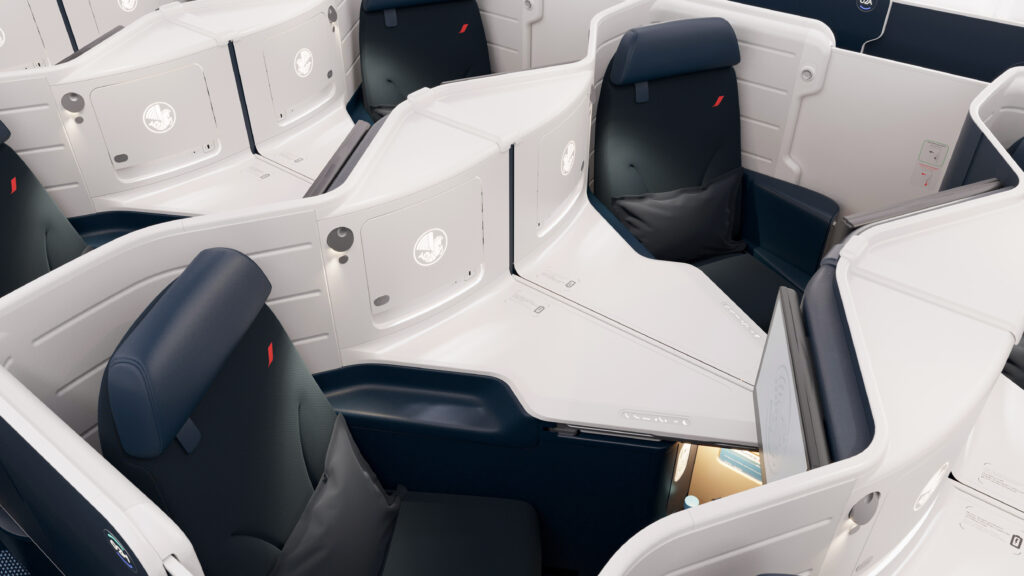 Business Class seats on Air France's Boeing 777-300ER. The cabin is a 1-2-1 configuration of blue seats with white thermoplastic shells.