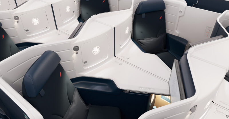 Business Class center pair seats on Air France Boeing 777-300ER. The cabin is a 1-2-1 configuration of blue seats with white thermoplastic shells.