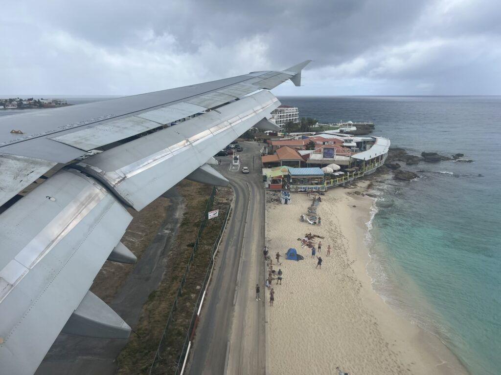 Looking out the aircraft window over St Maarten as the aircraft takes off and heads to New York.