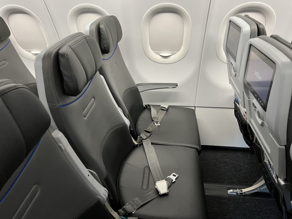 Economy seats on JetBlue's A320. The seats are grey with white thermoplastics.