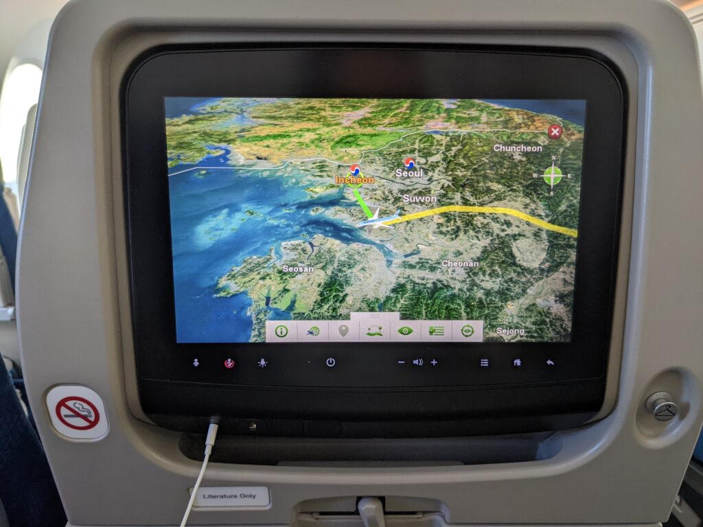 IFE screen embedded in the economy class seat of Korean Air 787. The screen is displaying the moving map.