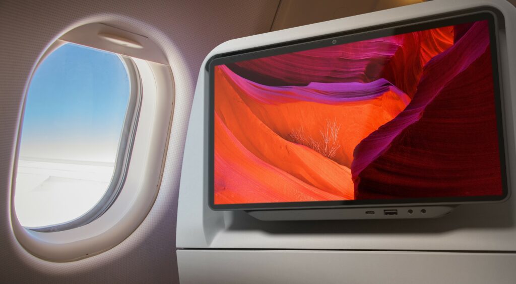 A computer rendering of an aircraft window and a large screen on the back of an aircraft seat. 