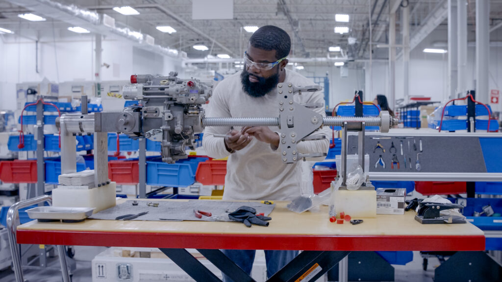 A man is working on in Collins Aerospace's new facility in Monroe