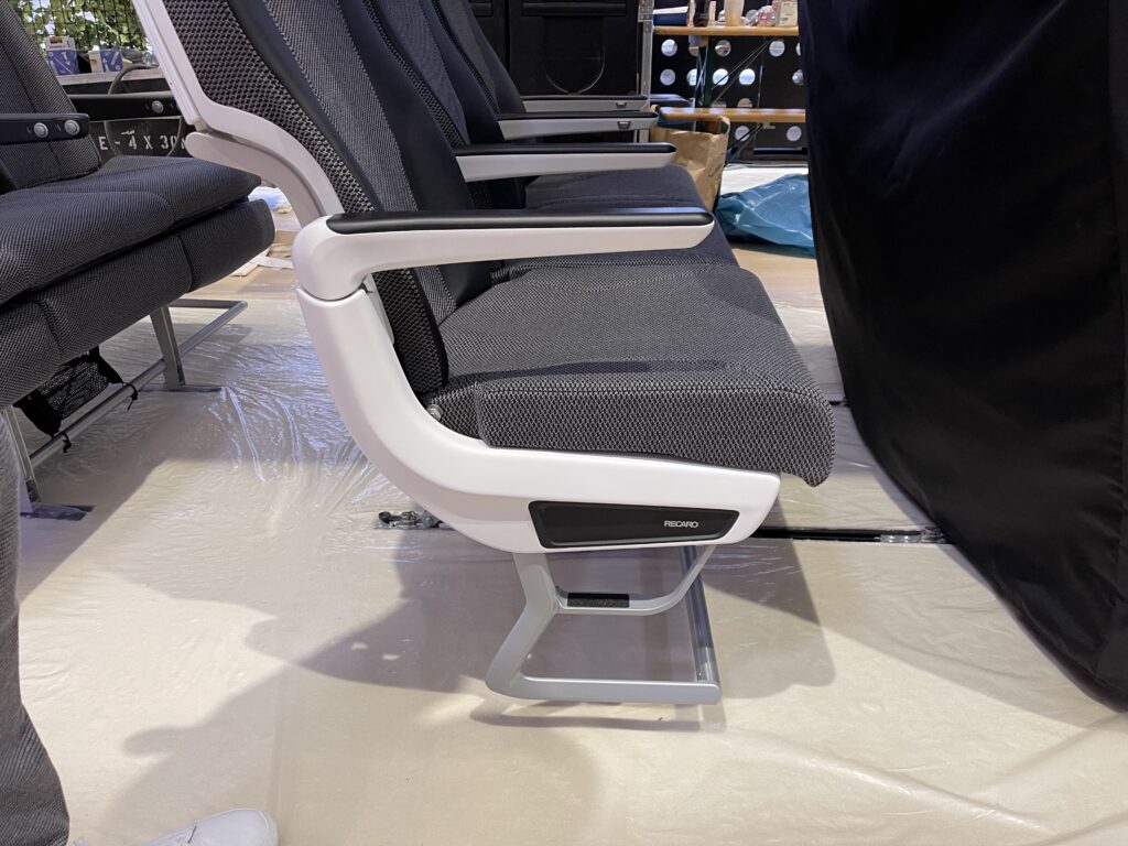 Recaro CL3810 seat triple on the show floor, close up of the armrest.