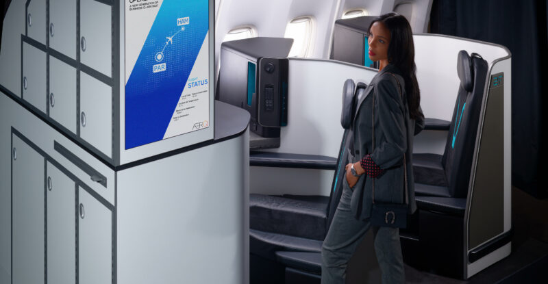 A women is standing in business class looking at the AERQ digital signage.