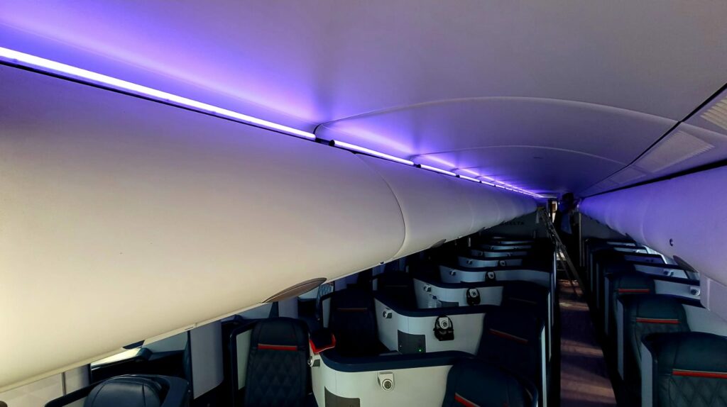 Mood lighting in purple, positioned above the bins and down the length of the business class cabin