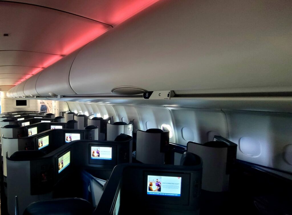 STG Aerospace on Delta Air Lines. LiTEMood led lighting in red, down the length of the business class cabin