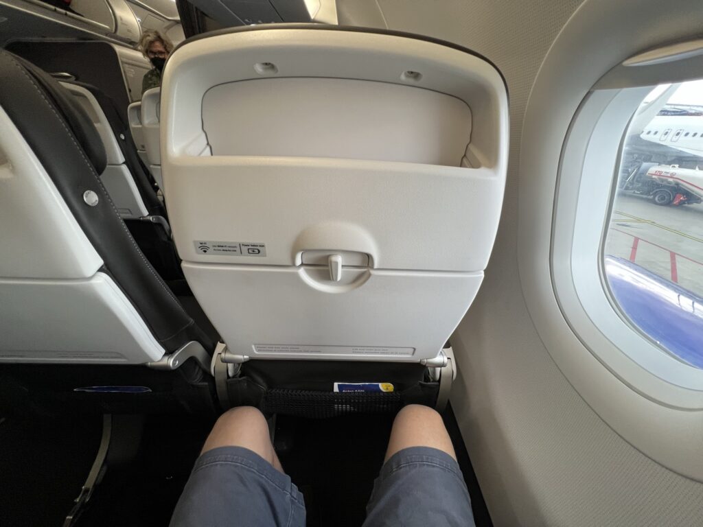 The author's legs are shown in this photo aboard the British Airways A320neo