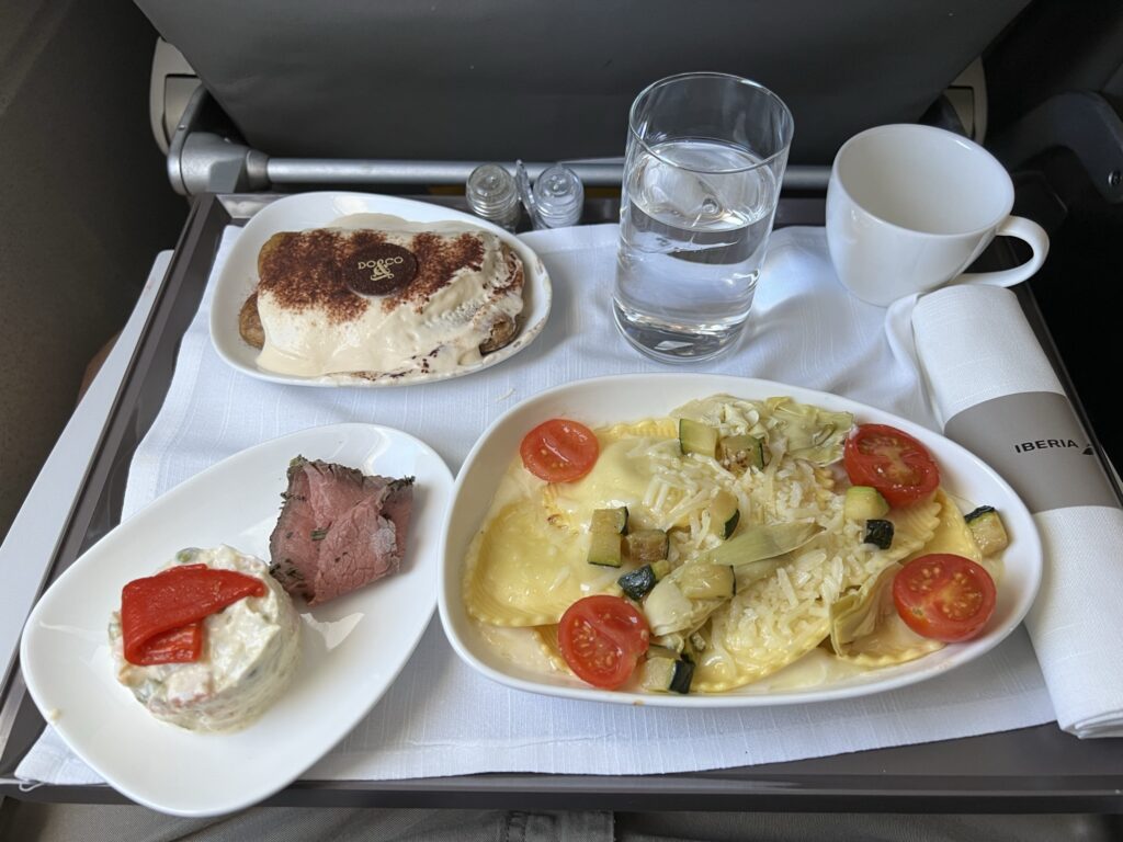 Ravioli dish onboard Iberia's A320 in Eurobiz. The dish is accompanied by a beef and potato salad side dish, and a delicious dessert.