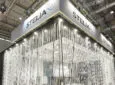 Stelia booth at AIX 2019 is draped in long lights.