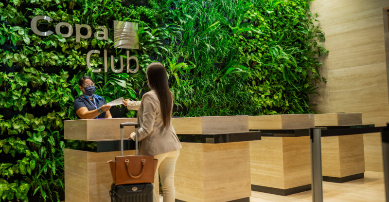 the entry way to the Copa Club at Tocumen International Airport is backed by a huge wall of greenery.