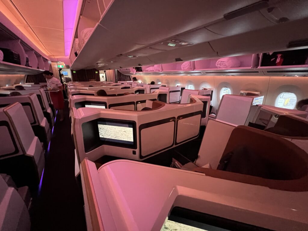 A photo of the Virgin Atlantic Upper Class A350-1000 cabin. The overhead bins and air vents in the center section are in view