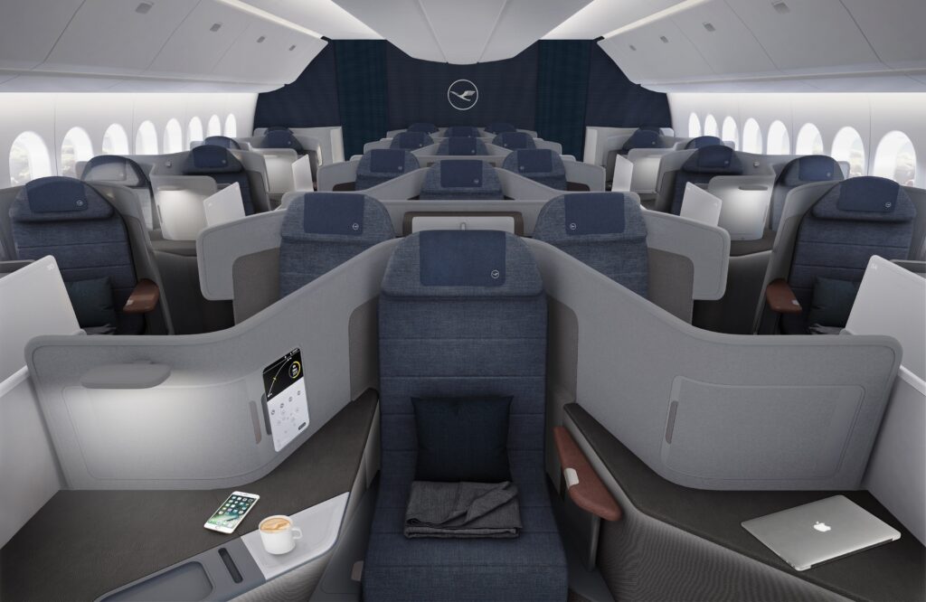 Business Class cabin on the Lufthansa 787-9 featuring bluish grey seat covers, and grey thermoplastics with brownish accent