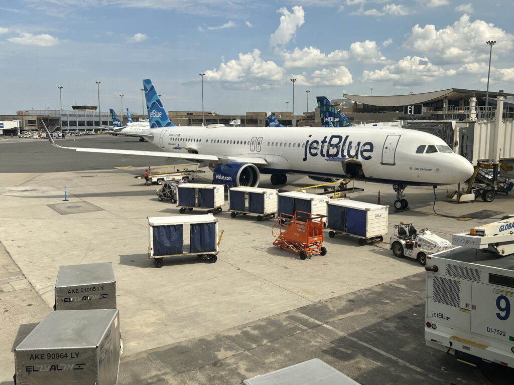 A JetBlue A321LR aircraft is at the gate waiting to board