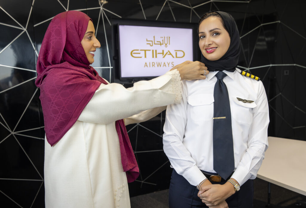 Captain Aisha Al Mansoori receives her stripes from her sister Mariam Al Mansoori