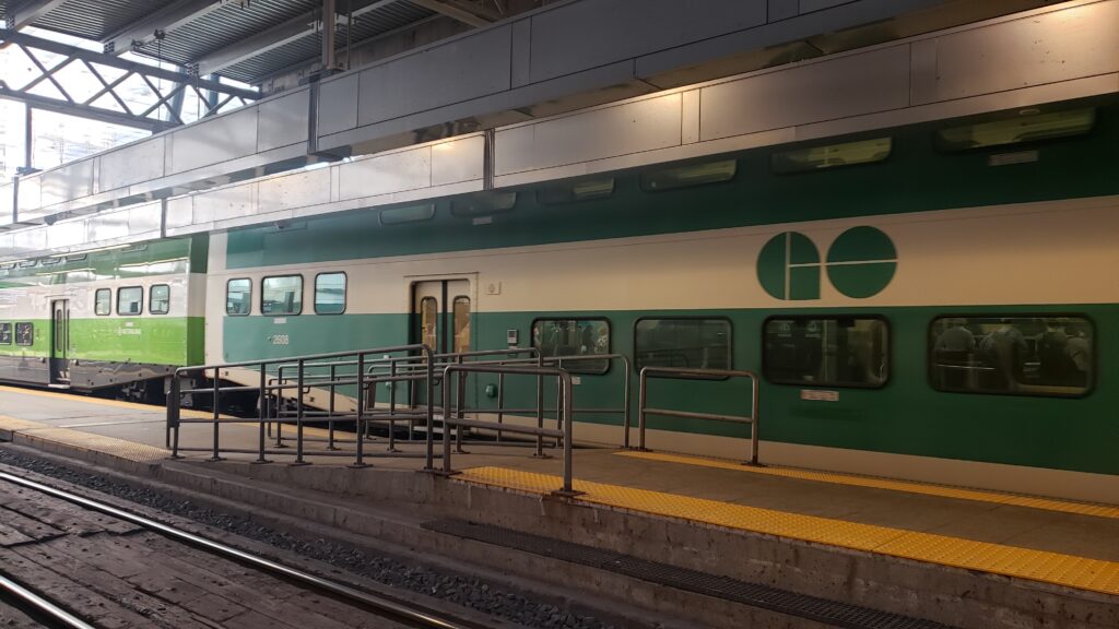 GO Train parked at Union Station with the word GO in green, with green stripes down the side