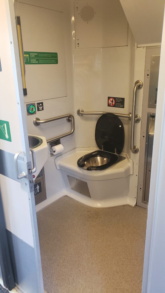 The door is open wide for a view of the larger interior of the accessible lav