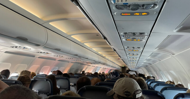 An A320 cabin full of air travelers. This image shows the tops of the traveler heads and the PSUs running down the length of the aircraft. AirFi targets this market.