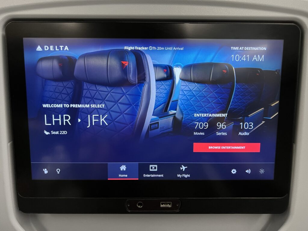 A close up shot of the Delta IFE system, showing a photo of the Premium Select cabin as a 'home' screen