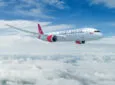 Virgin Atlantic aircraft in flight on a bright sunny day.