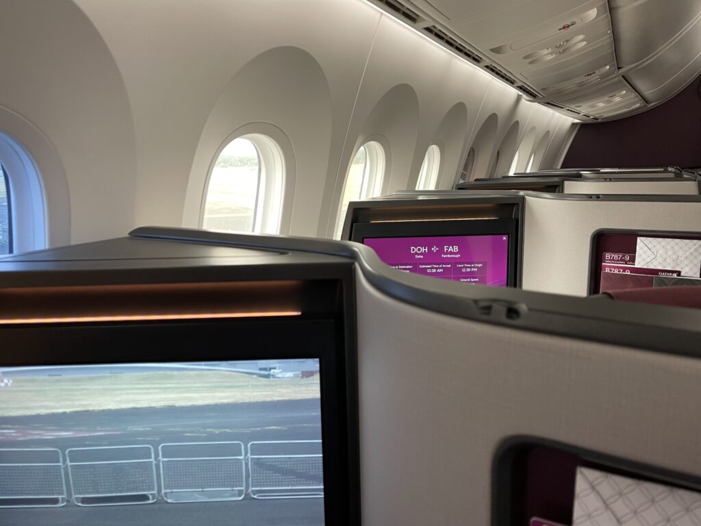 A photo of a business class cabin with the tall height of the suites evident.