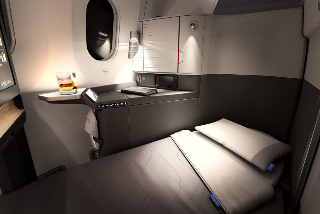 Flagship Suite on the Boeing 787-9 for American Airlines in lie-flat bed position, with a pillow and blanket