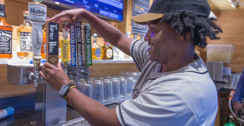 A man is pouring beer from the tap at O’Hare airport