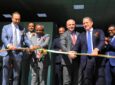 Inauguration of the new facility, Ethiopian Sky Technologies. A group of male executives are cutting the ribbon.