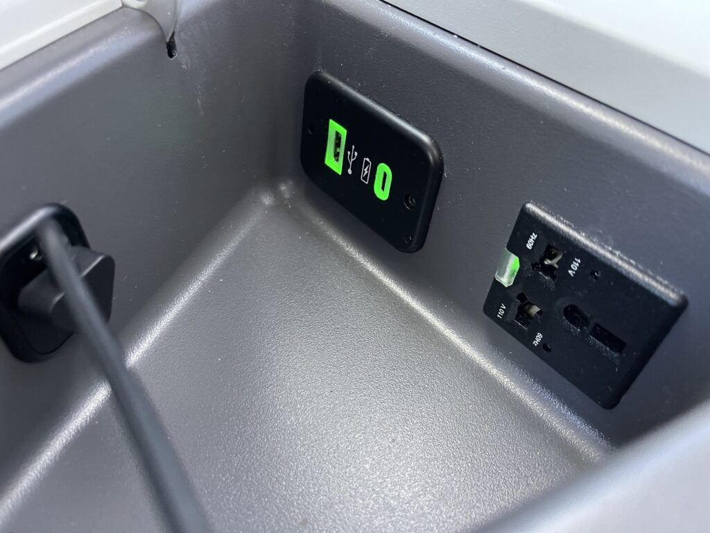 A close up of the in-seat power ports on Air Canada's Signature seat