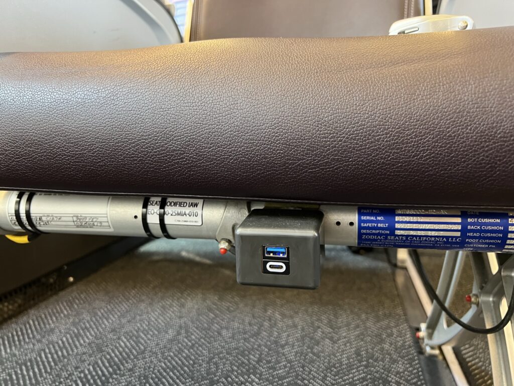 A close up photo of the USB power ports at the seat on the CRJ550 operated by United Airlines