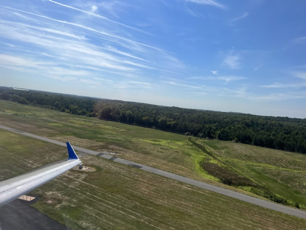 Looking out the window to see the wing tip of the United Airlines CRJ550 as it takes off. 